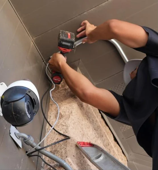 C&C tech installing an outdoor security camera