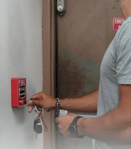 C&C tech testing a fire alarm pull station