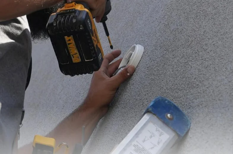 C&C tech mounting a sensor on a ceiling